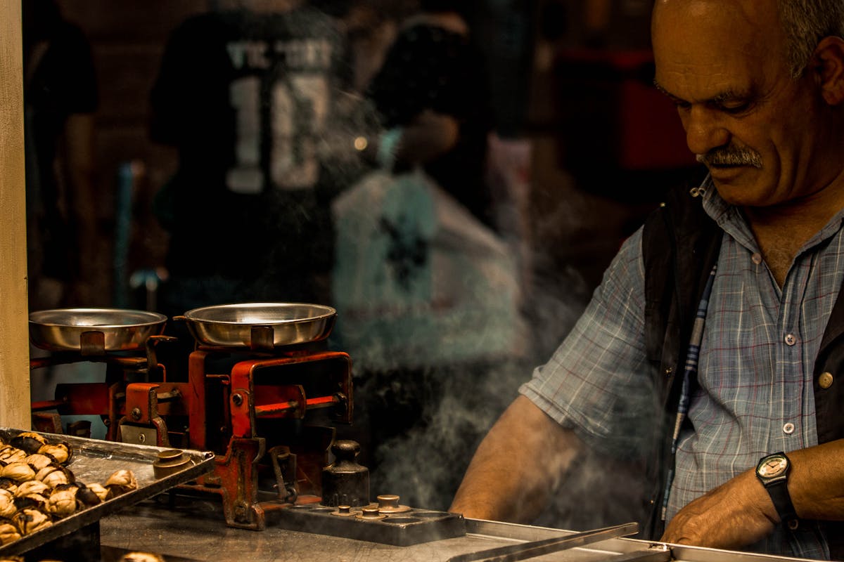 Street vendor grilling amidst billowing smoke