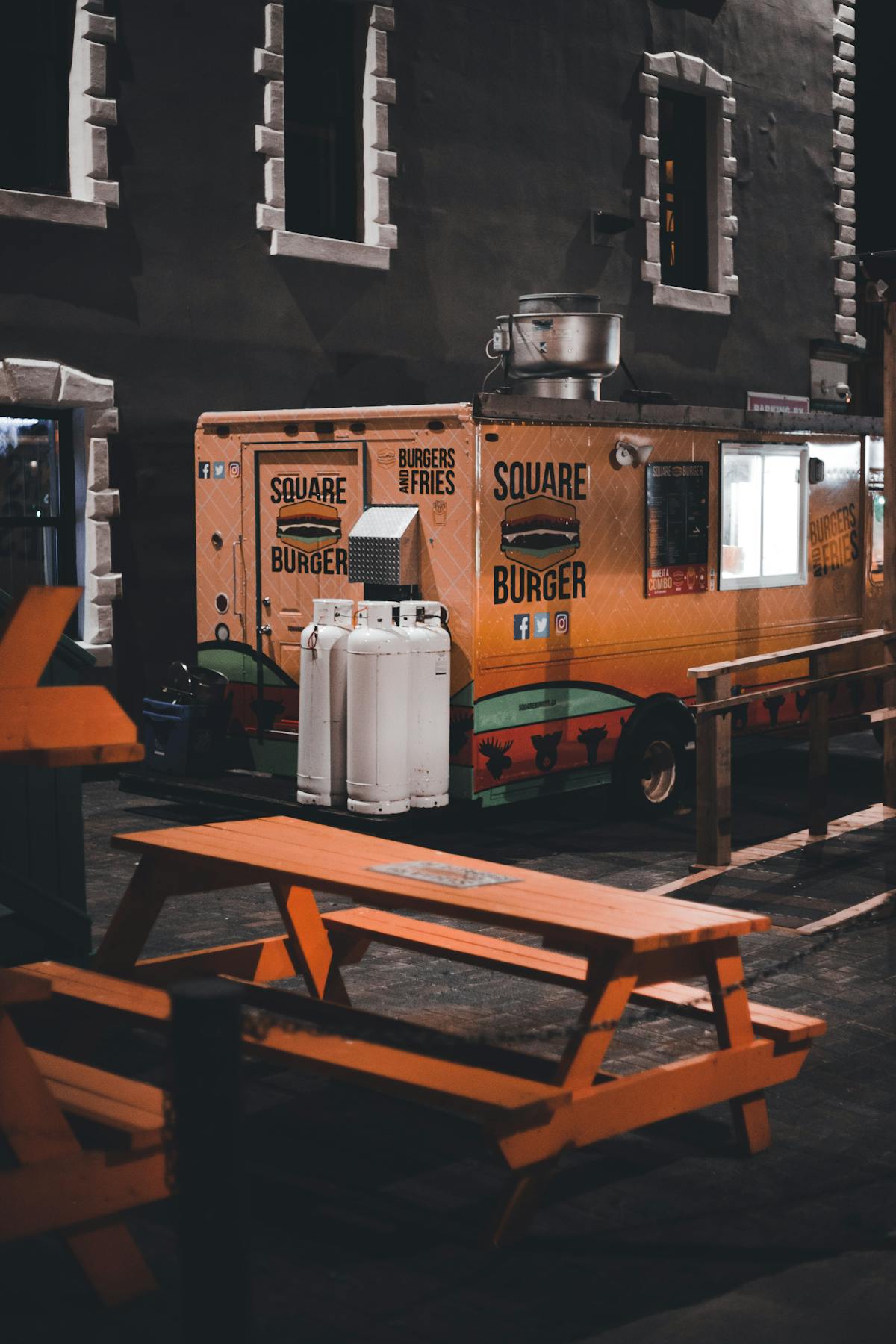 Food truck with outdoor seating area at night